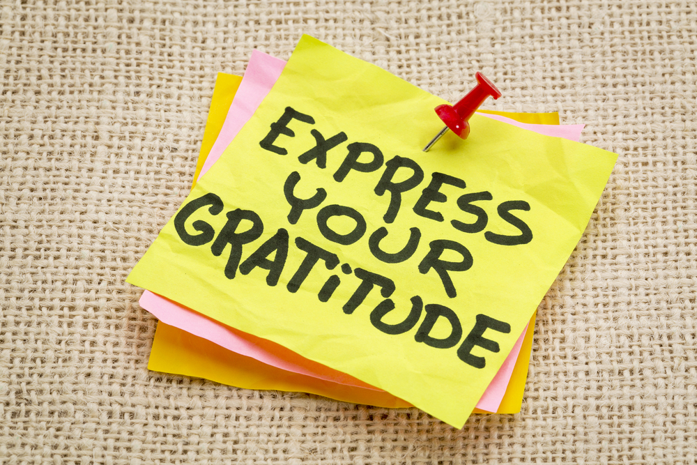 Express Your Gratitude - Advice On A Sticky Note Against Burlap Canvas